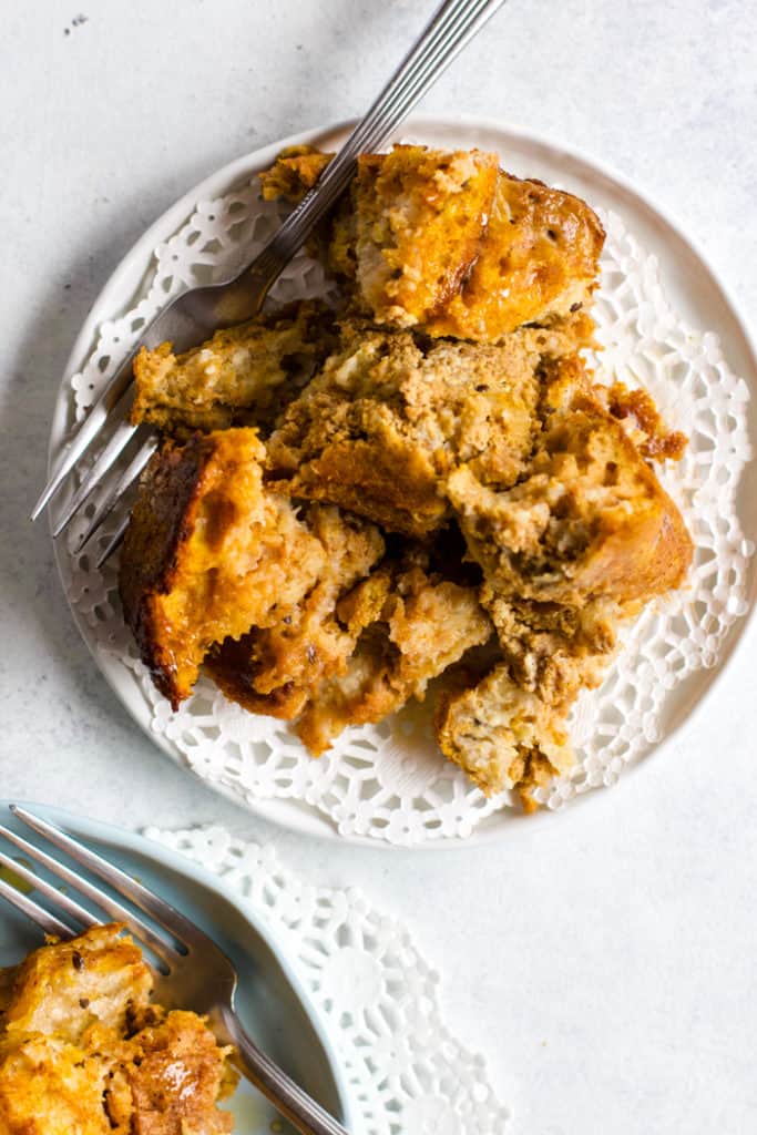 Piece of pumpkin pie French toast bake on white plate with fork