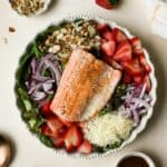 Strawberry salmon salad in white ceramic bowl.