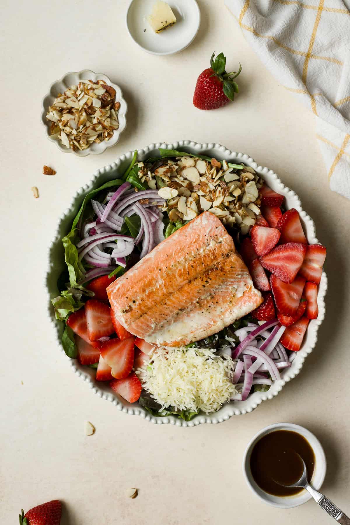 Strawberry salmon salad in white ceramic bowl.