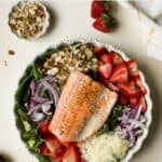 Strawberry salmon salad in white ceramic bowl.