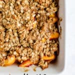 Baked healthy peach crisp in white ceramic baking dish