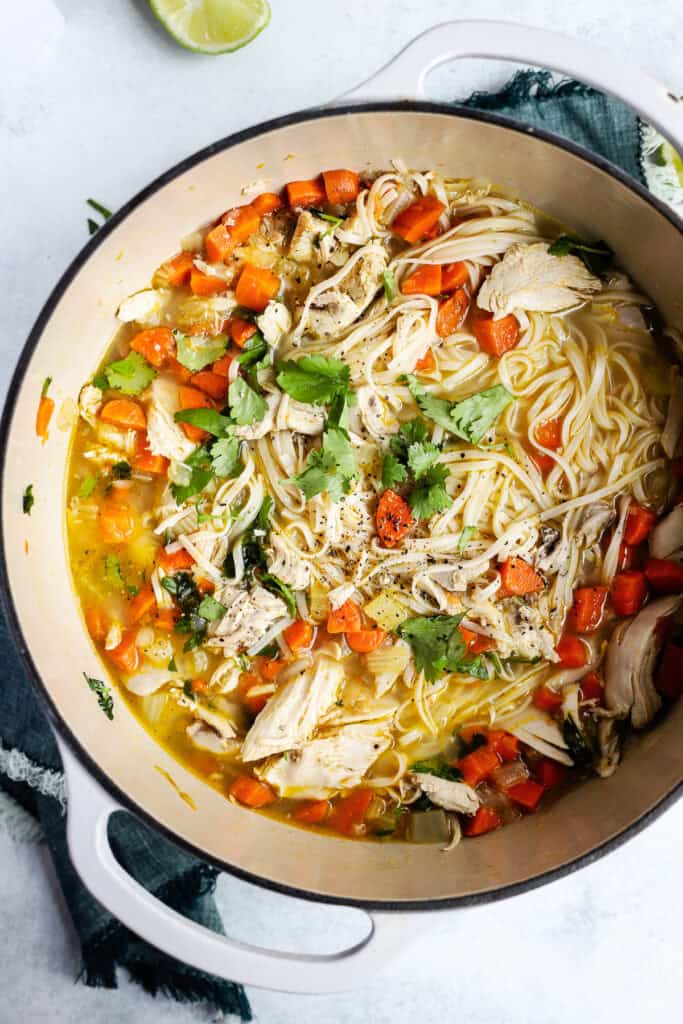 Dutch oven with large batch of ginger lime chicken noodle soup.