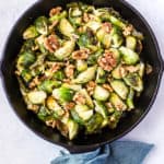 Maple walnut roasted Brussels sprouts in cast iron skillet