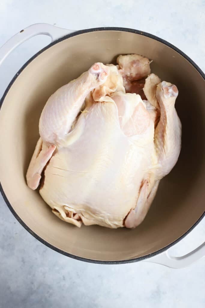 Whole chicken in dutch oven for soup.
