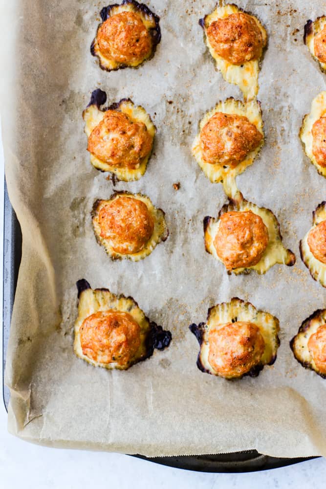 Spanish baked chicken meatballs fresh out of the oven on parchment-lined sheet pan