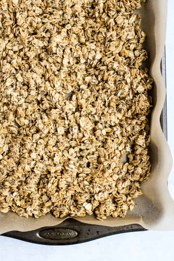 Coconut chia granola mixture before baking, spread onto sheet pan with parchment paper