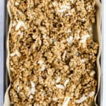 Simple coconut chia granola on parchment paper lined sheet pan