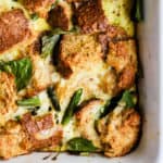 Fully baked spring veggie breakfast strata in white ceramic baking dish