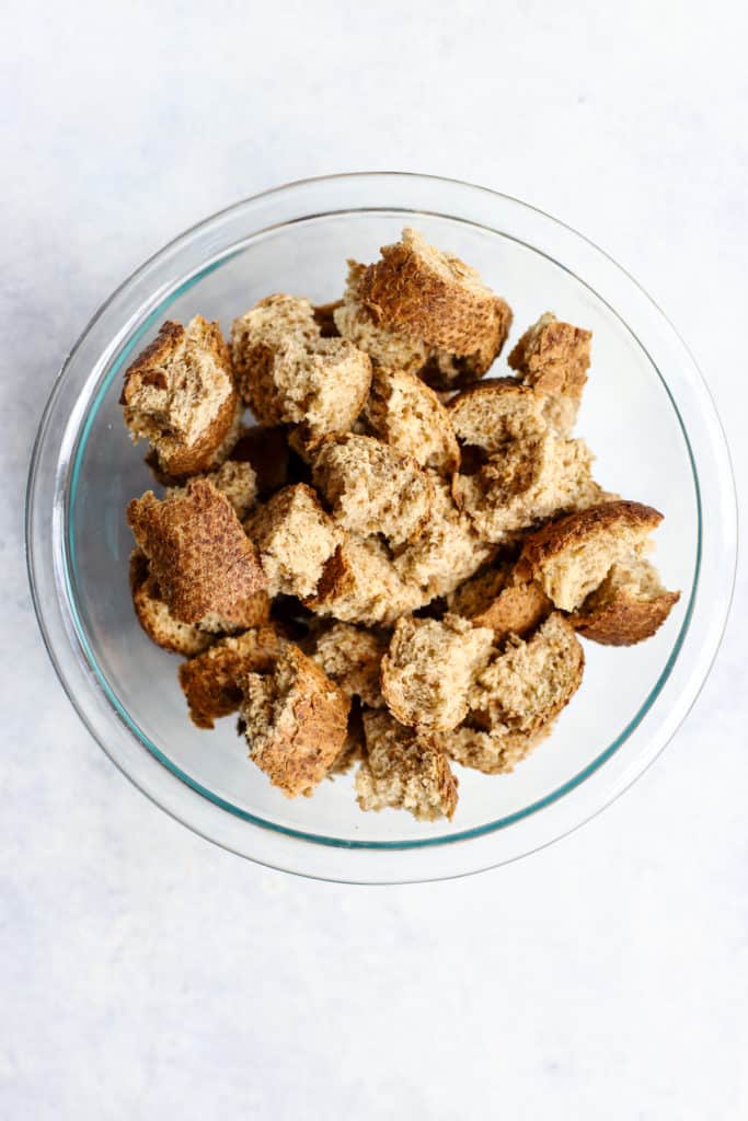 Whole grain bread cubes in a glass bowl.