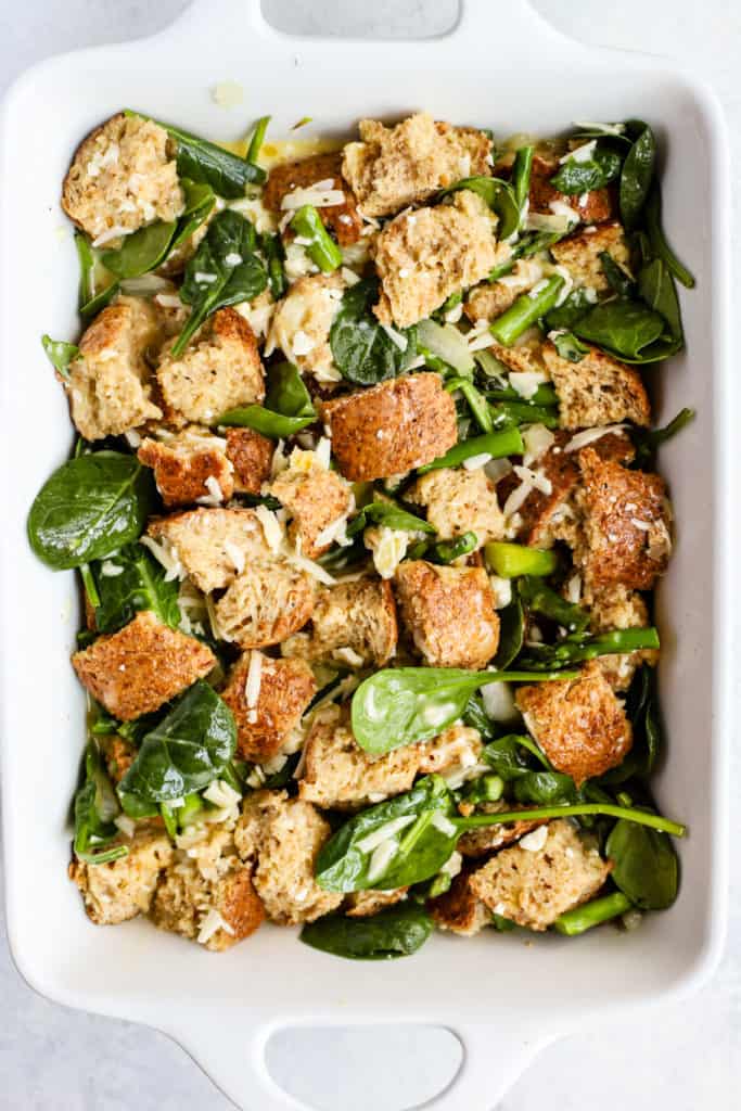 Bread cubes, spinach, asparagus, and cheese all coated in egg and milk mixture.