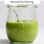 Basil dressing in a small jar.
