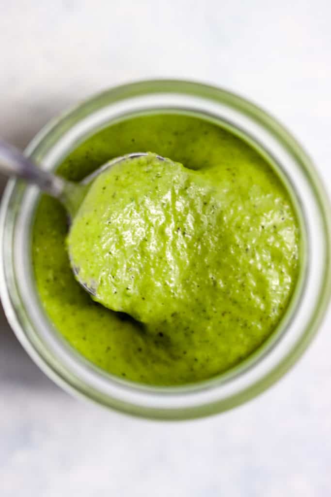 Homemade basil vinaigrette in small Weck jar with spoon