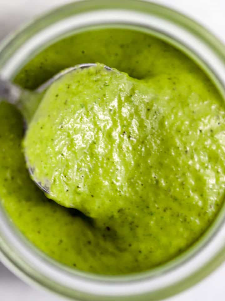 Homemade basil vinaigrette in small Weck jar with spoon