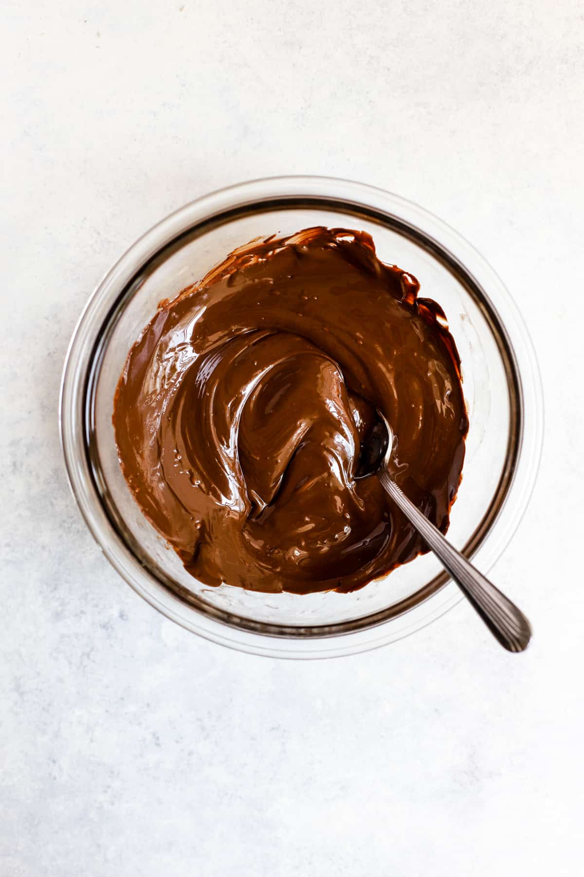 Melted dark chocolate in small bowl.