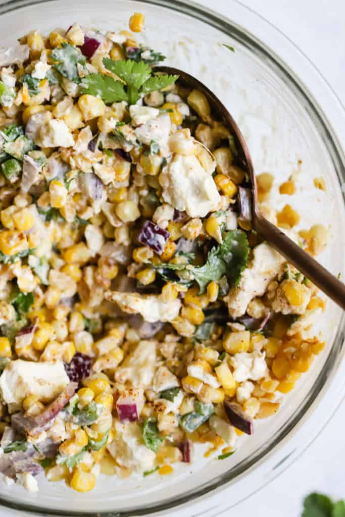 20-minute healthy street corn in a glass bowl with spoon.