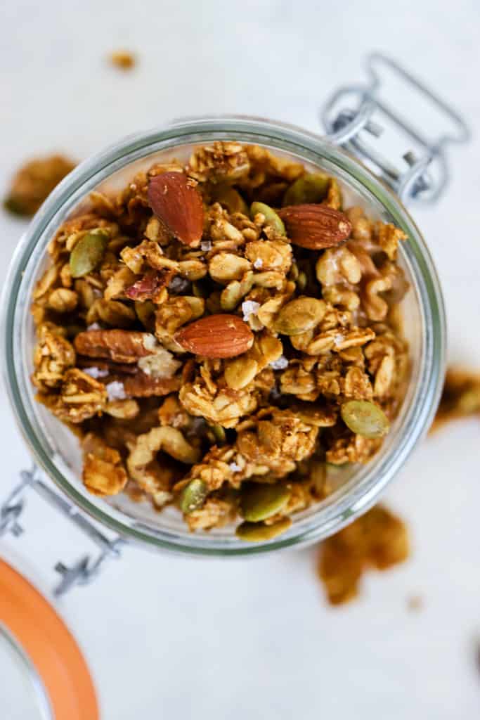 Healthy pumpkin granola in glass jar with flip-top lid