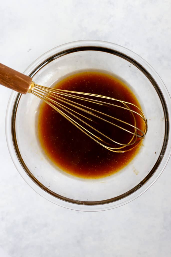 Maple syrup, coconut oil, pumpkin, and vanilla extract heated and whisked together in clear glass bowl