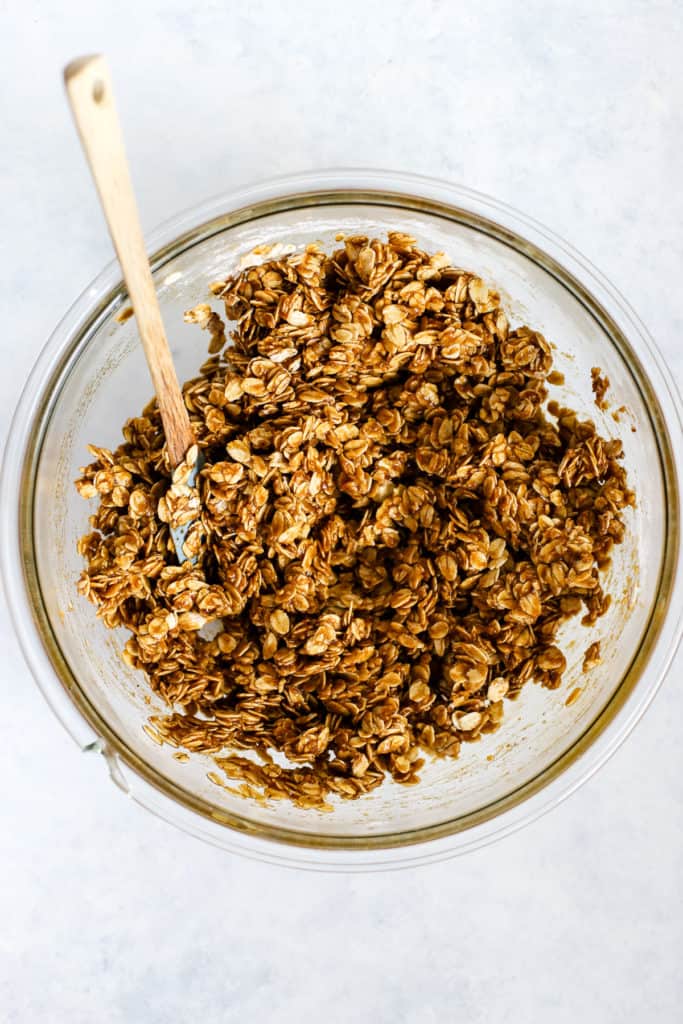 Pumpkin granola ingredients mixed in clear glass bowl without nuts