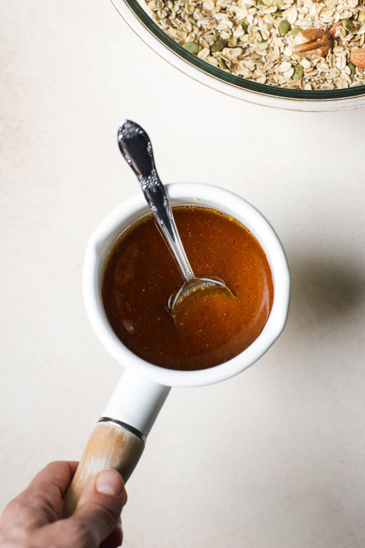 Small pot with pumpkin, maple syrup, and coconut oil heated together.