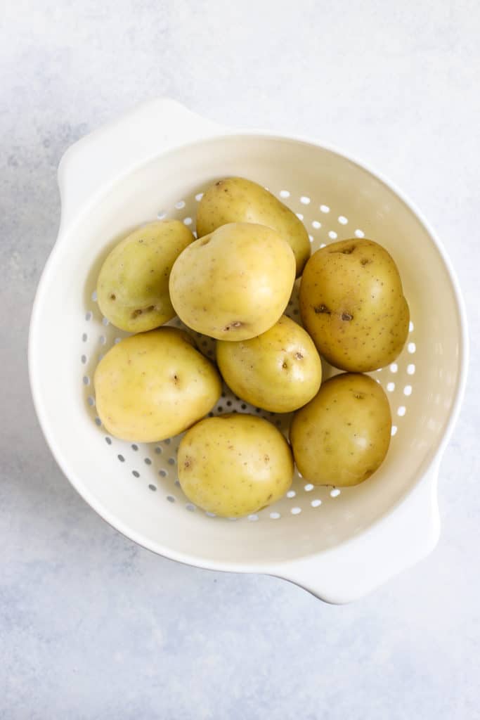 Yukon gold potatoes in white strainer