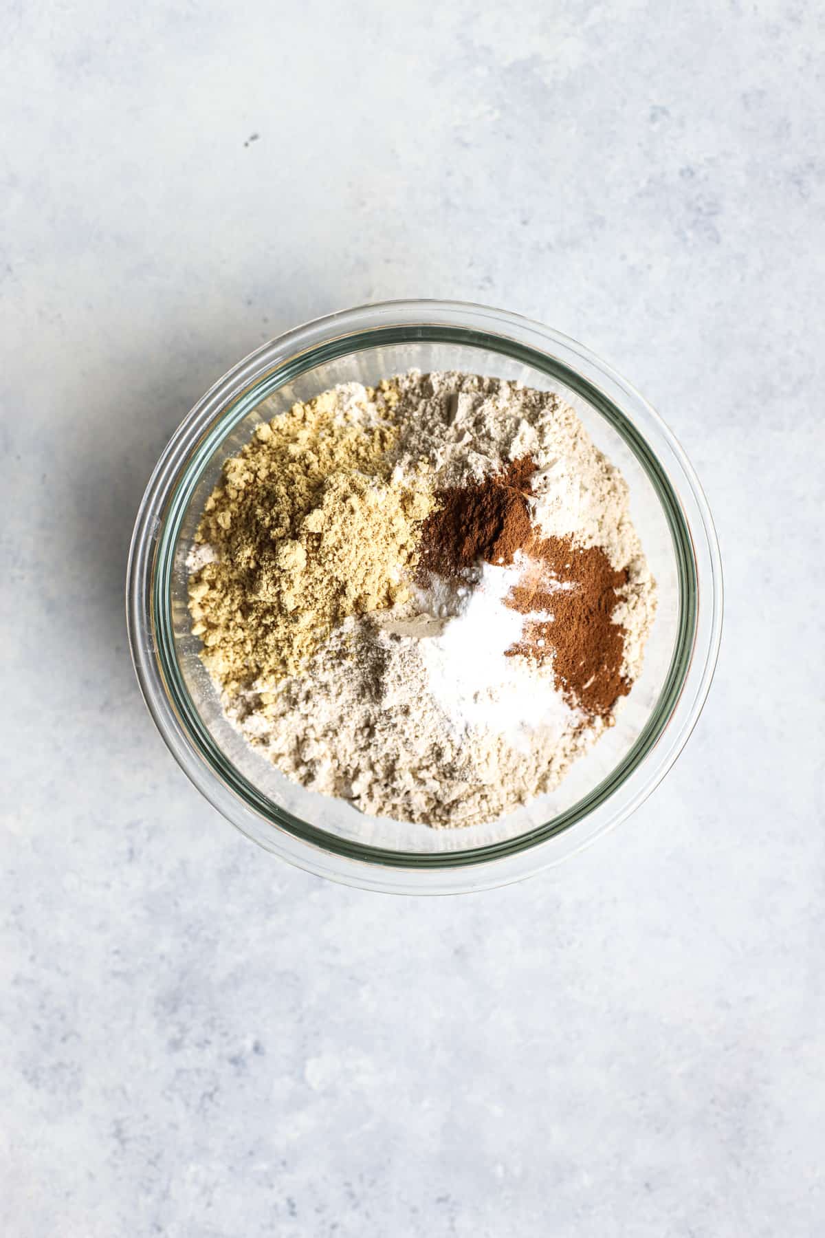 Dry ingredients for healthier ginger molasses cookies in a bowl.