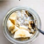 Protein overnight oats in small jar with banana slices and walnuts.