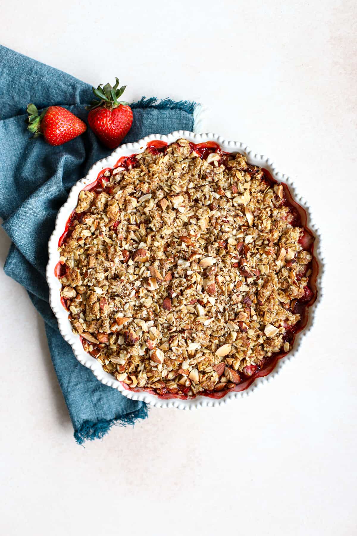 Wholesome strawberry crisp in round baking dish.