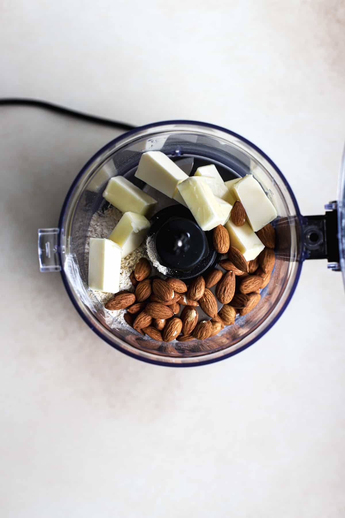 Almonds, butter, flour, and spices in food processor.