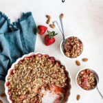 Strawberry crisp in white baking dish and served into small bowls.