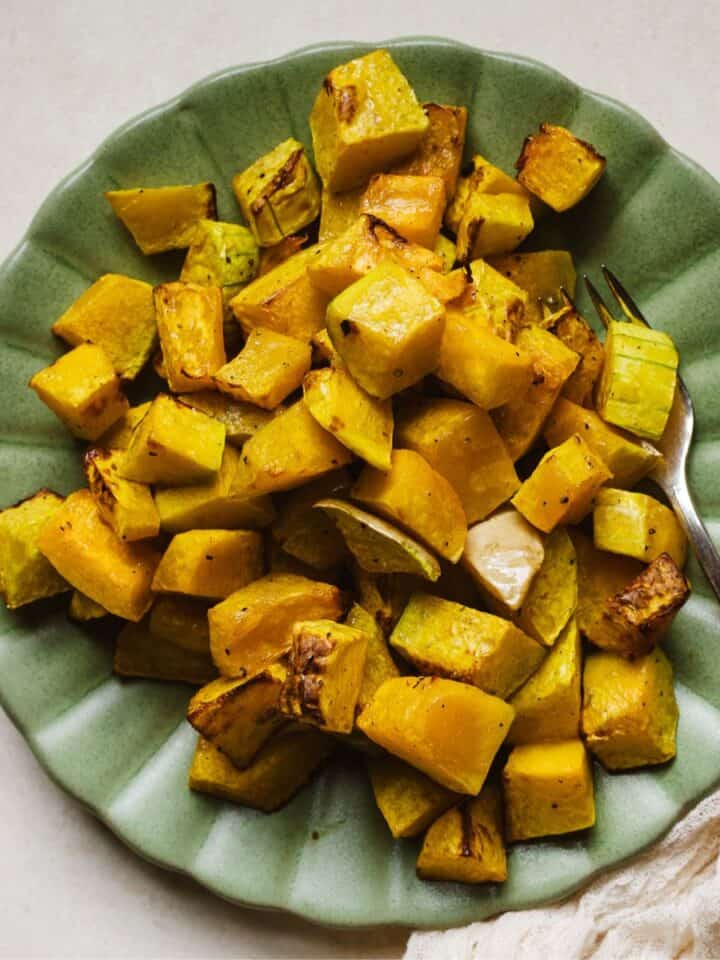 Air fried butternut squash cubes on a plate.