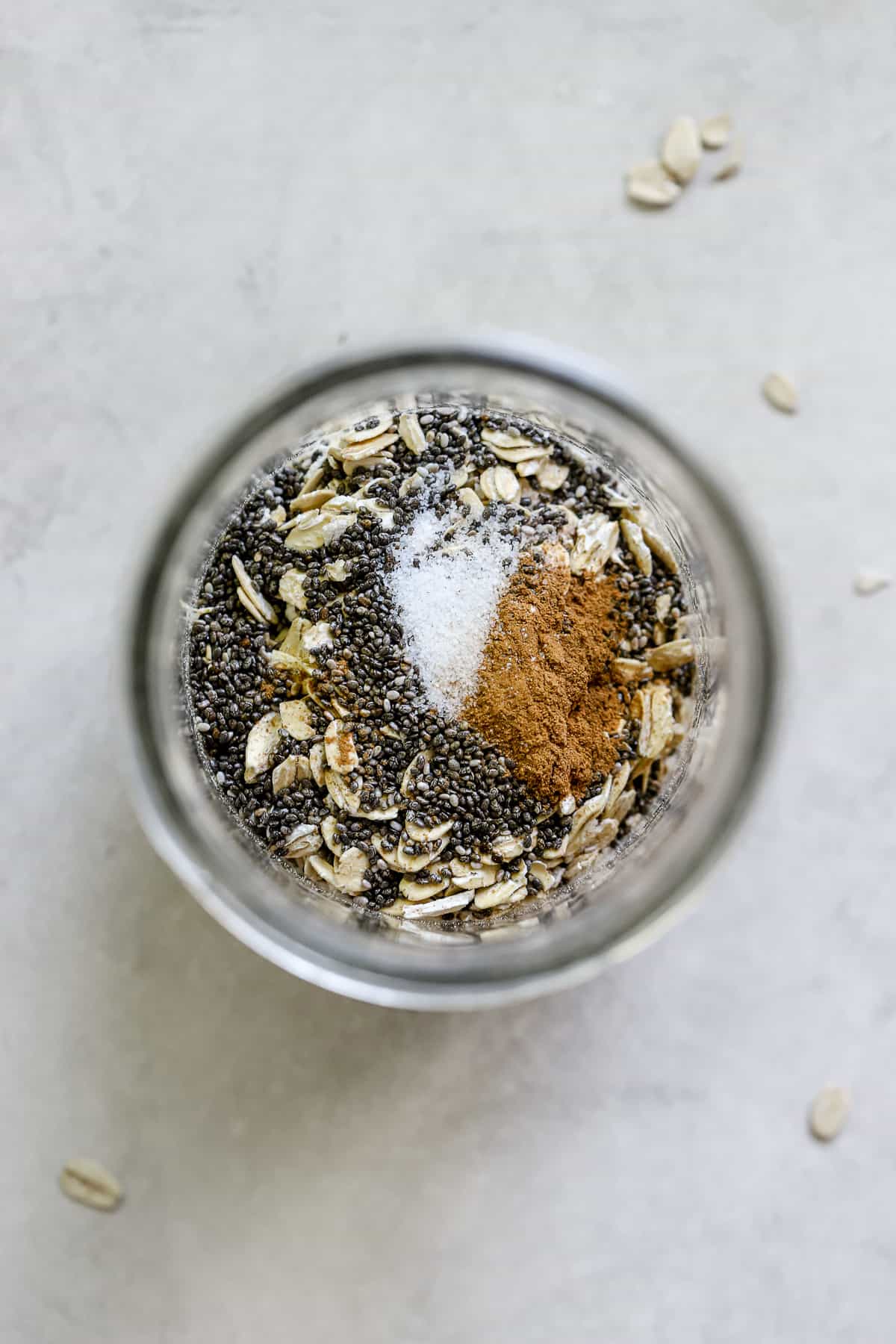 Addition of rolled oats, chia seeds, cinnamon, and salt to a widemouth Mason jar