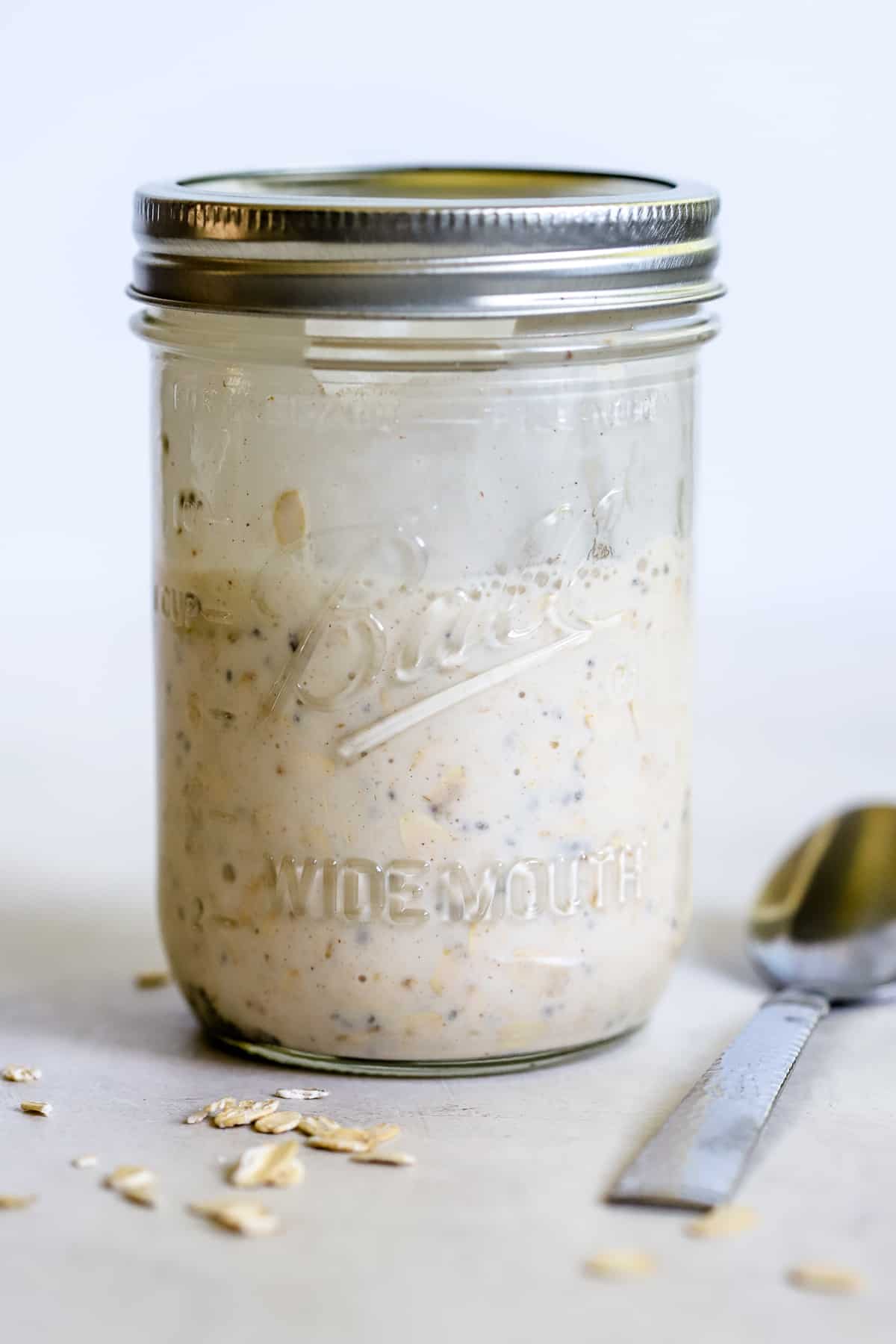 Overnight oats mixture in a widemouth Mason jar, ready to soak in the fridge