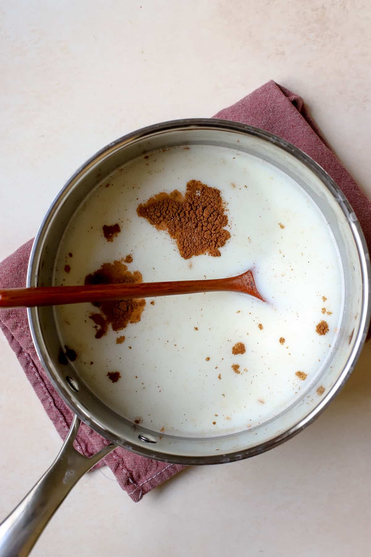 Milk, salt, maple syrup, and cinnamon added to toasted steel cut oats