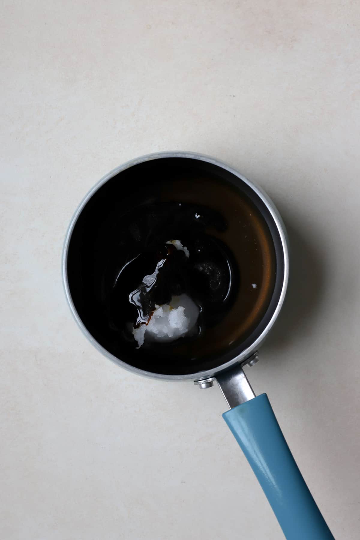 Coconut oil, maple syrup, and molasses in small sauce pan