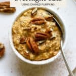 Pumpkin overnight oats topped with pecans in a small white bowl.