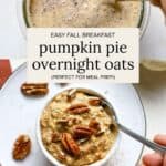 Stirring pumpkin pie overnight oats together and serving in a small bowl topped with pecans.
