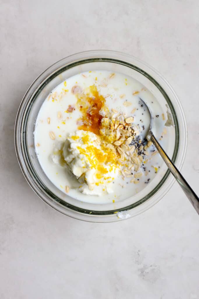 Overnight oats ingredients in a bowl before being mixed.