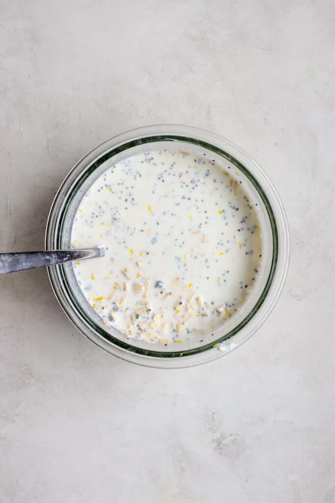 Overnight oats base mixed together in a bowl with a spoon.