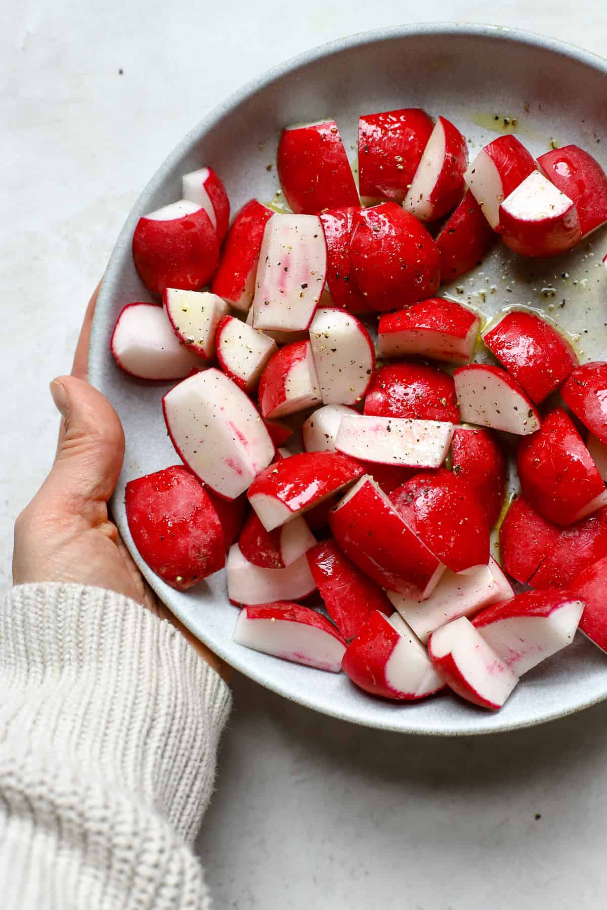 Seasoned chopped radishes in blue bowl.