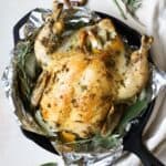Simple roasted chicken with herbs in cast iron skillet.