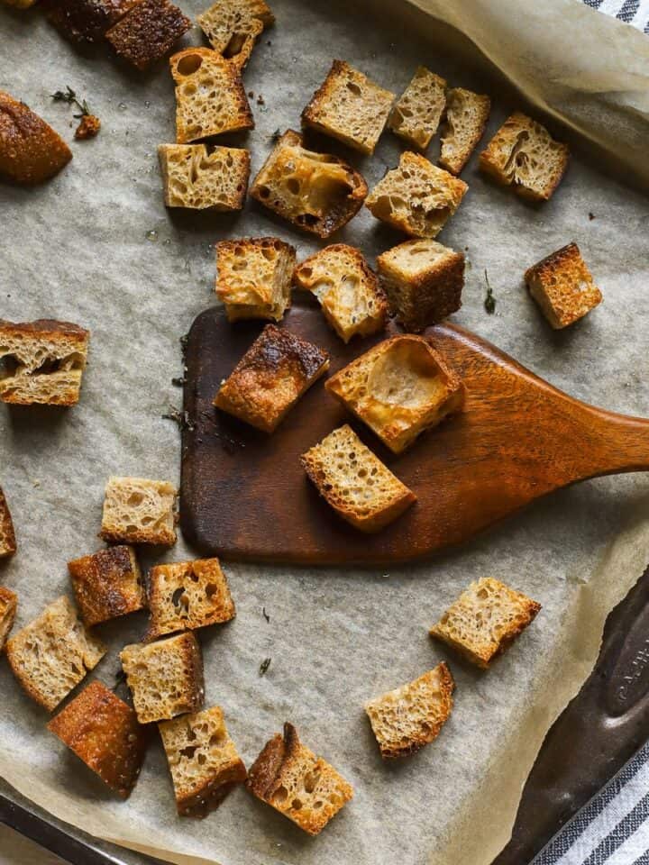 Homemade sourdough croutons on sheet pan.