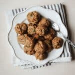 Baked turkey meatballs piled onto a white plate with fork.