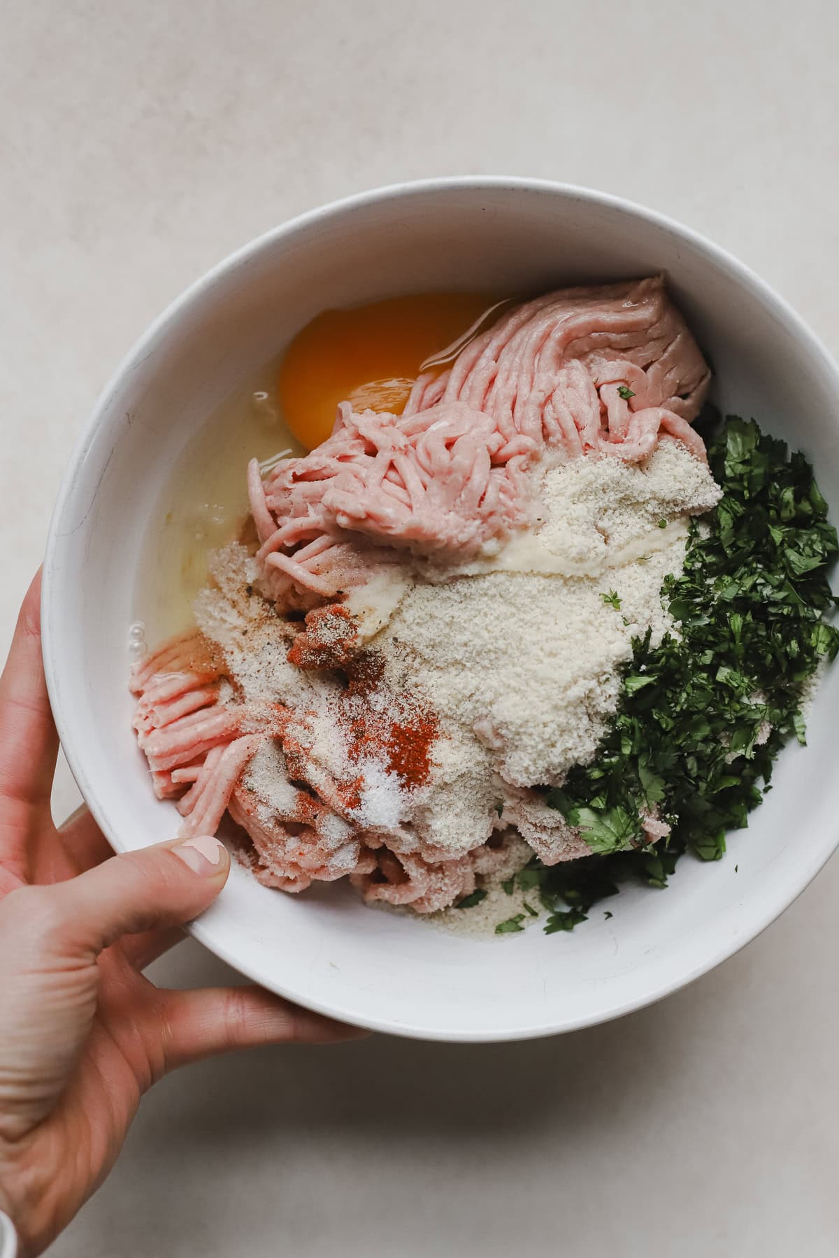 Meatball ingredients in bowl before being mixed.