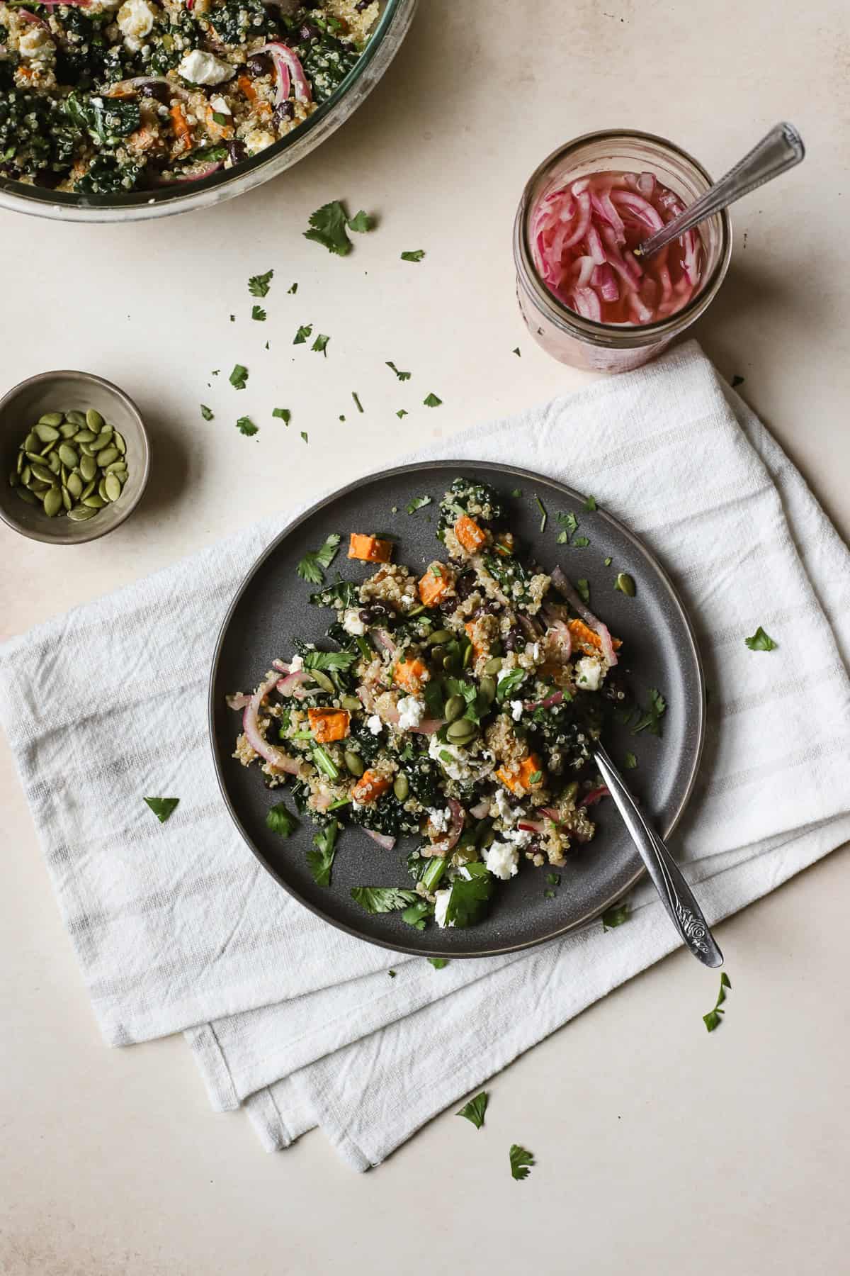 Black bean quinoa salad on gray plate with fork.