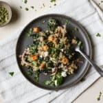 Black bean quinoa salad on gray plate with fork.