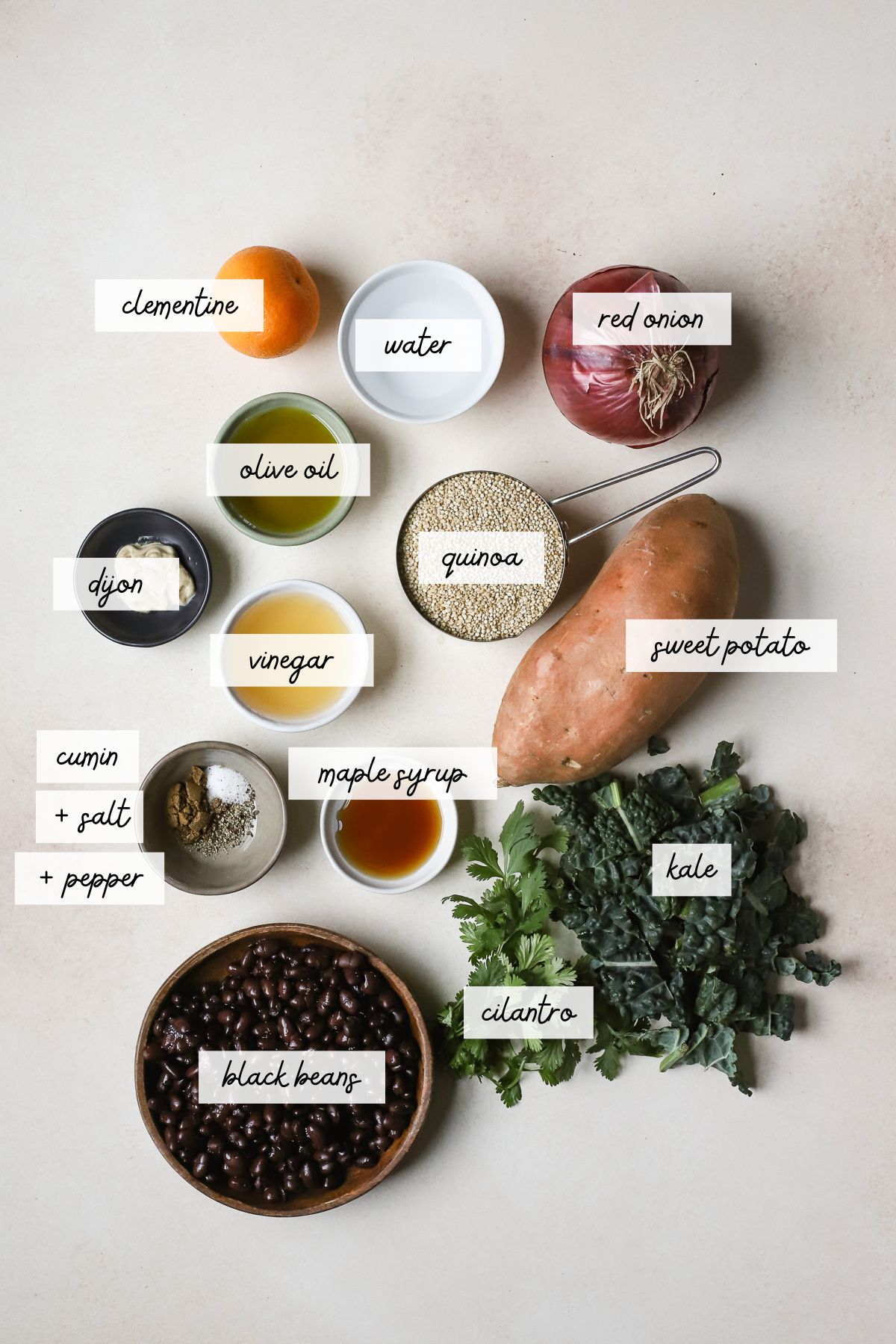 Ingredients needed to make a black bean quinoa salad with sweet potatoes and kale.