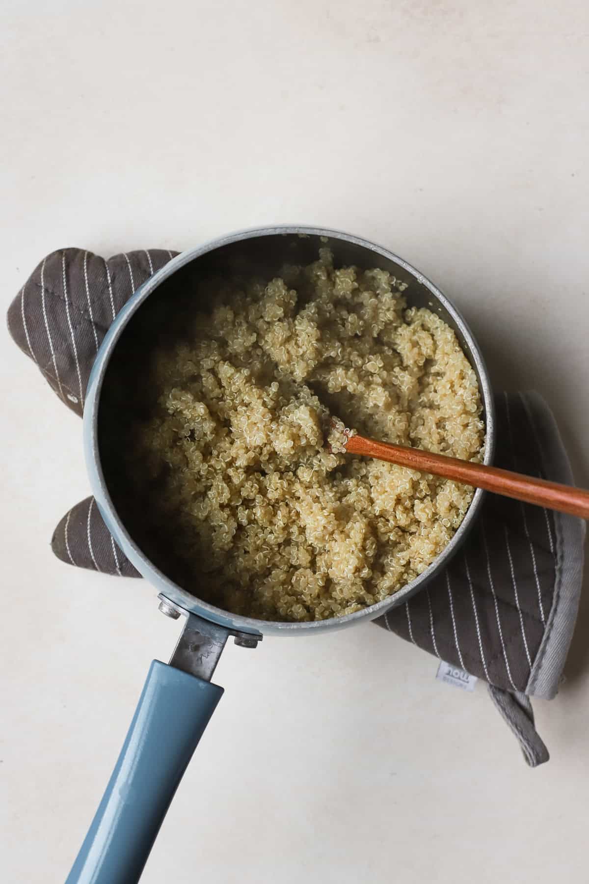 Fully cooked quinoa in small pot.