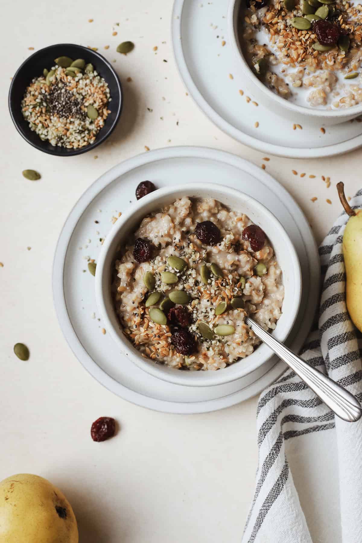Small bowl of Instant Pot steel cut oats with spoon and toppings.