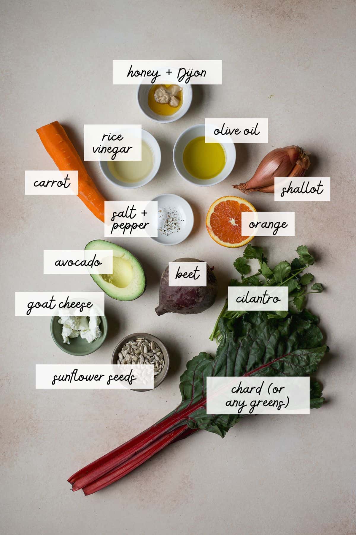 Ingredients needed to make greens salad with beets, carrots, and citrus vinaigrette.