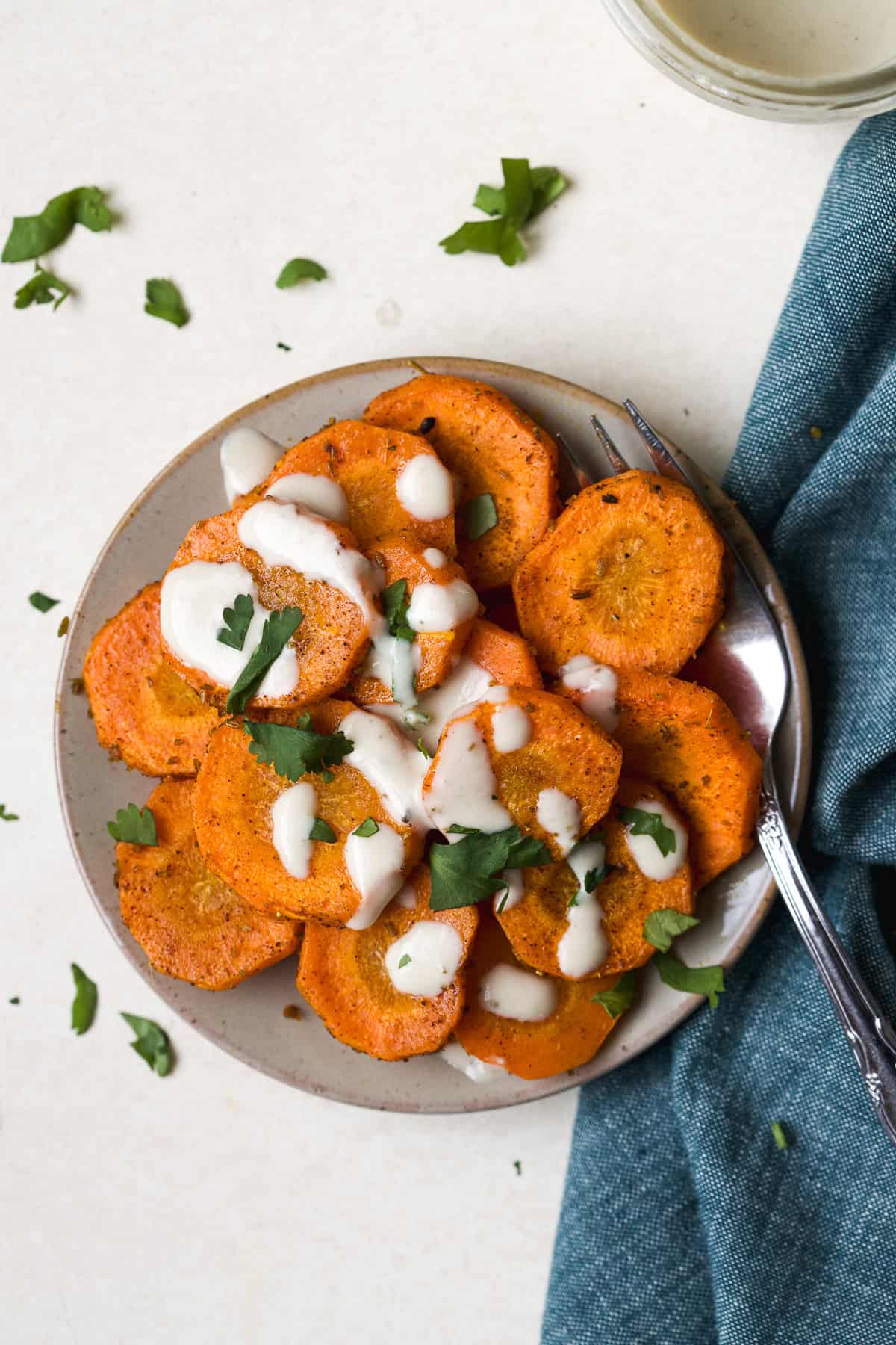 Moroccan-spiced roasted carrots with tahini sauce drizzled over the top.